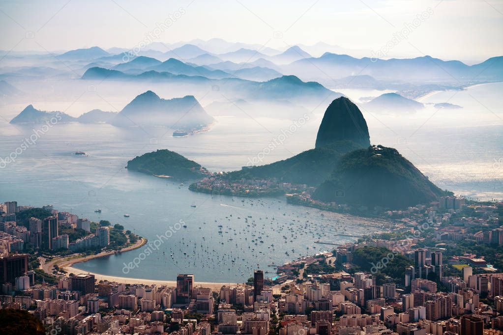 The Sugarloaf mountain in morning mist and Botafogo bay