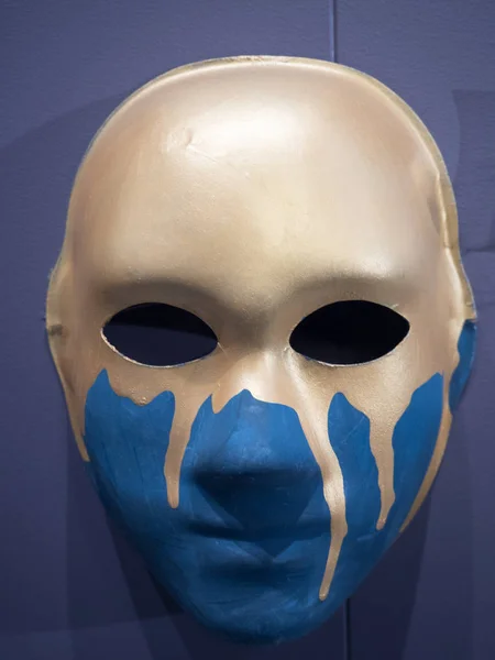 human face mask for a costume party on the wall