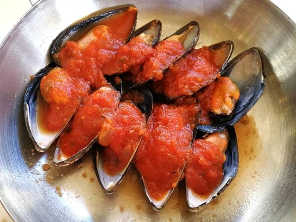 Een schaaltje mosselen in een mediterrane tomatensaus — Stockfoto