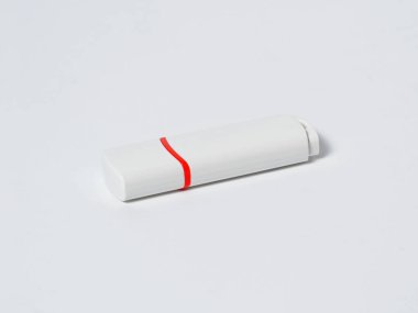 White usb flash drive isolated with a red stripe on the white background