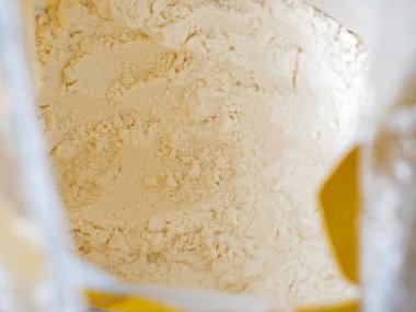 Close-up top view of a bag of white wholemeal flour