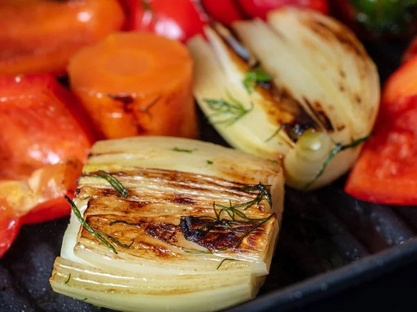 Close-up side view of juicy vegetables fried in a pan. The concept of vegetarianism, proper nutrition.