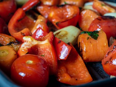 Close-up side view of juicy vegetables fried in a pan. The concept of vegetarianism, proper nutrition.