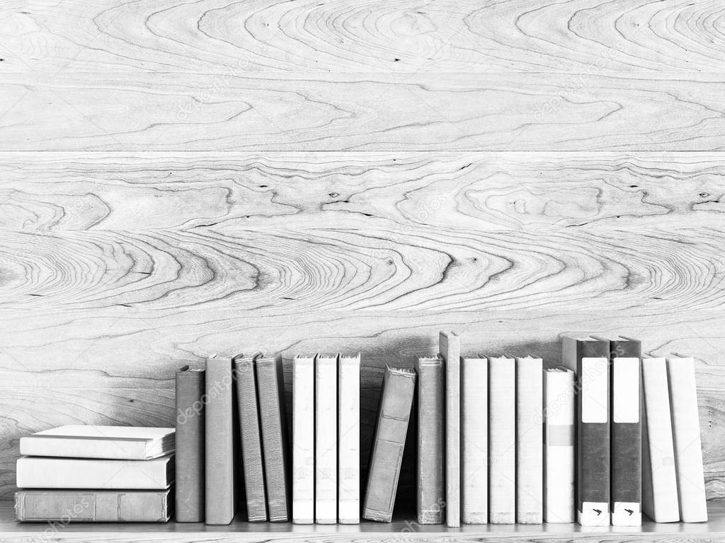 Black and white old books on a wooden shelf. 3D illustration