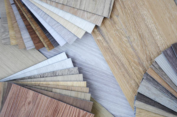 laminate wood texture floor :oak tile, maple tile, chestnut tile, walnut tile, balsam tile,   Samples of laminate and vinyl floor tile on wooden Background. Laminate use in the house, Hospital, Townhouse, Condominium, Hotel, Apartment, Department