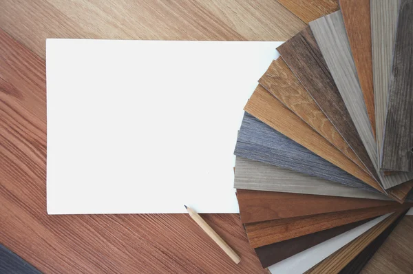 Samples of laminate and vinyl floor tile on wooden Background — Stock Photo, Image