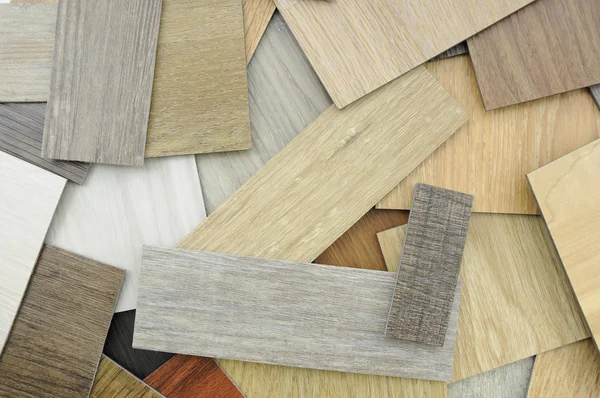 ,   Samples of laminate and vinyl floor tile on wooden Backgroun — Stock Photo, Image