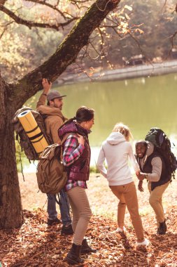 Men helping women go to river clipart