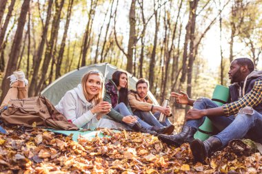 Young friends travelers in forest clipart