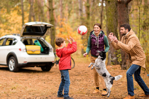 Happy family playing with ball 
