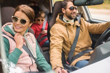 Happy family travelling by car clipart