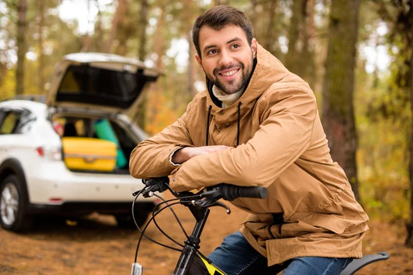 Sorrindo homem sentado na bicicleta — Fotografia de Stock
