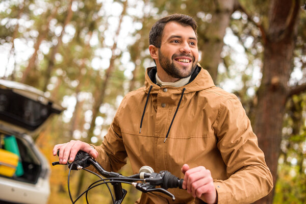 Smiling man sitting on bicycle 