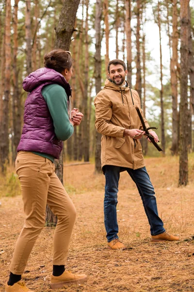 Couple collecting firewood in forest — Free Stock Photo