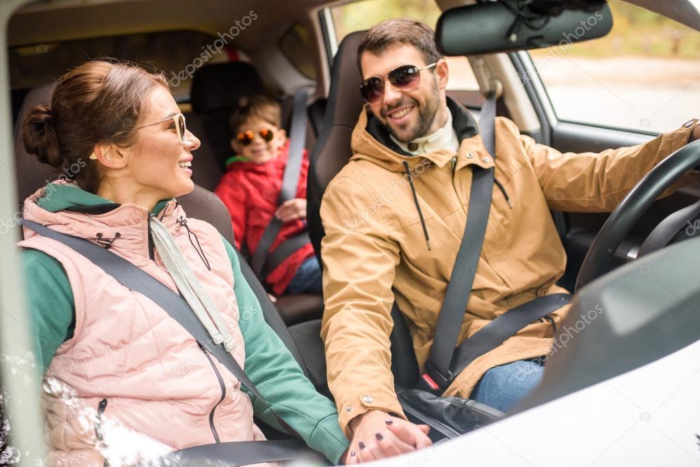 Happy family travelling by car