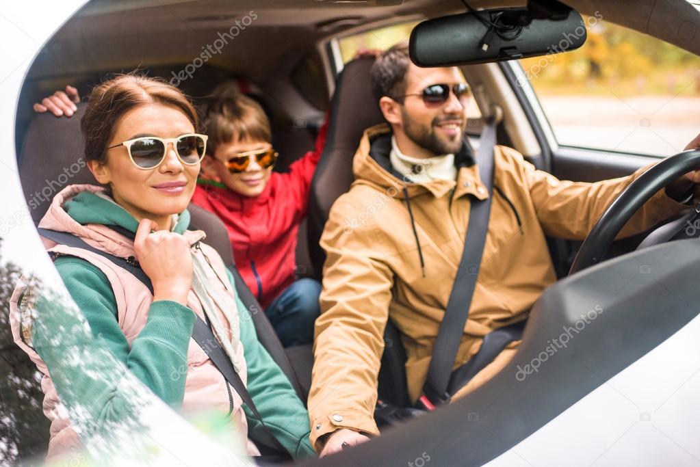 Happy family travelling by car