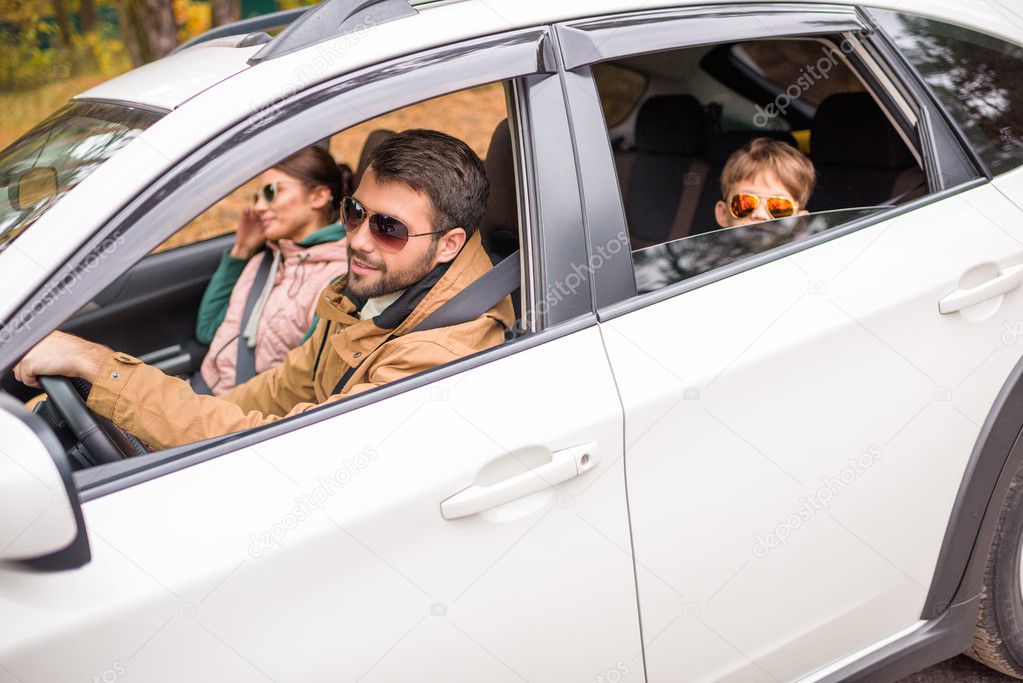 Happy family travelling by car