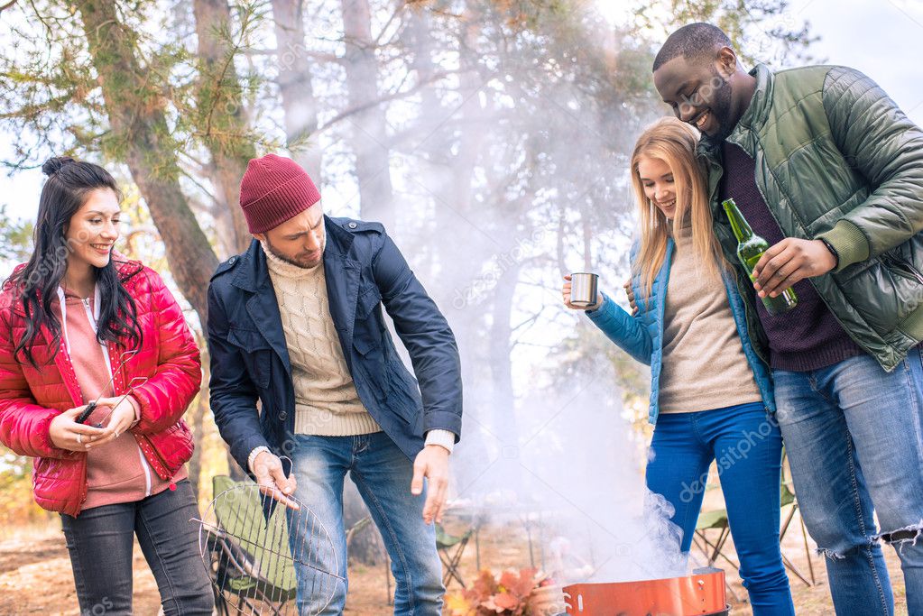 Smiling friends having fun in campsite