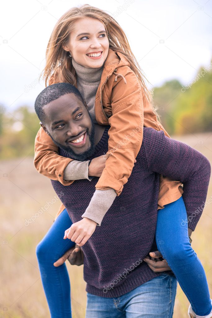 Happy young couple piggybacking