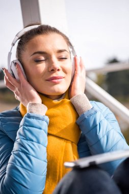 Beautiful woman in headphones listening music  clipart