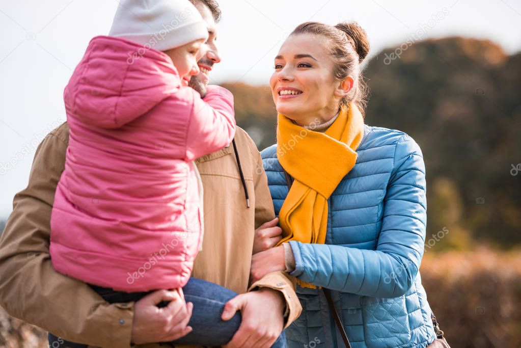 Happy family walking in park