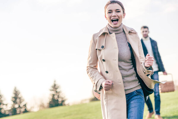 Happy woman running on green meadow