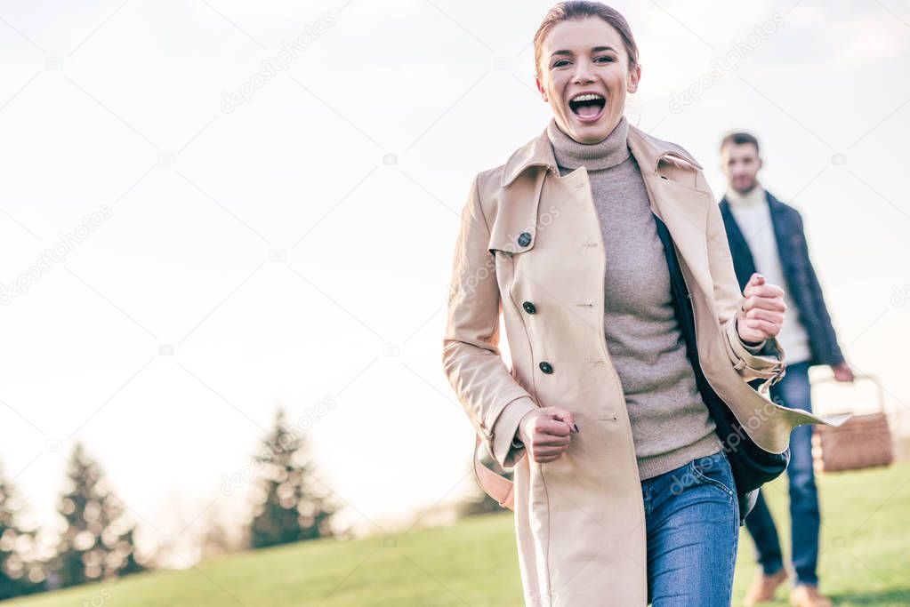 Happy woman running on green meadow