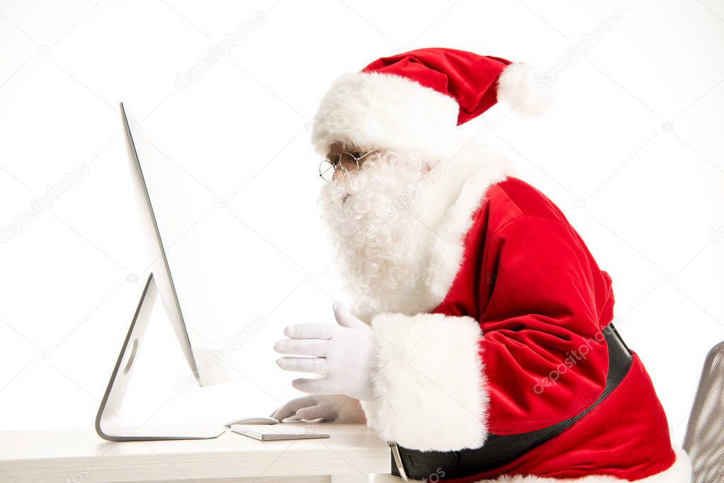 Santa Claus looking at computer 