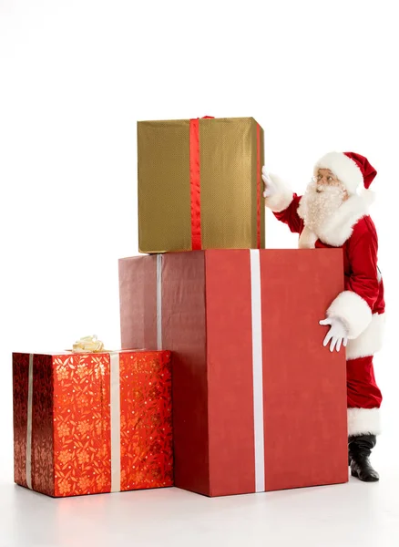 Santa Claus with pile of Christmas gifts — Free Stock Photo