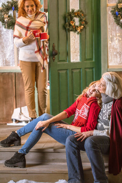Smiling grandmother and granddaughter hugging