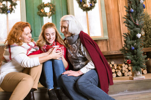 Family drinking hot tea on stairs