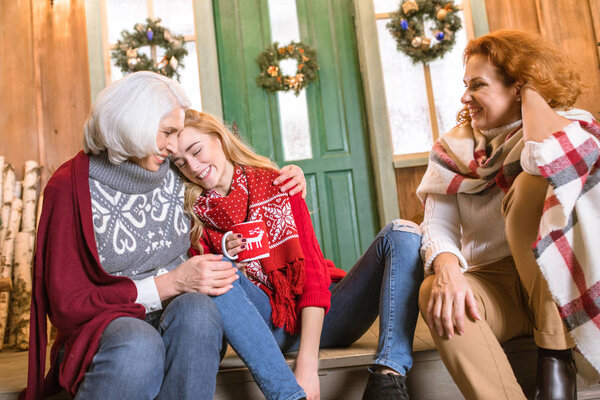 Family drinking hot tea on stairs
