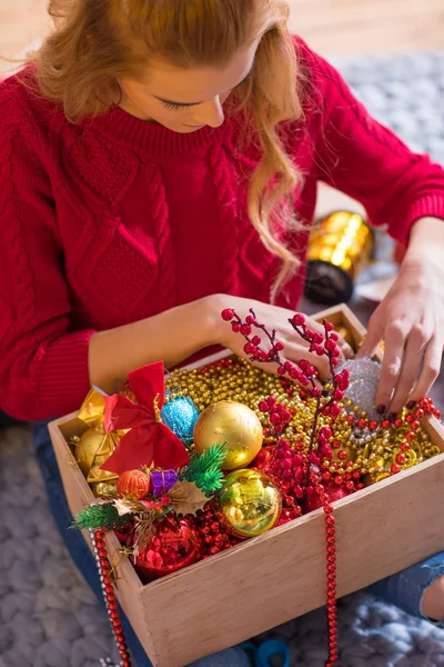 Woman holding box with baubles — Stock Photo, Image