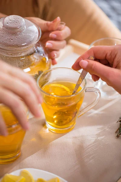 Woman mixing sugar in tea — Stock Photo, Image