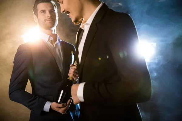 Stylish men with champagne bottle — Stock Photo, Image