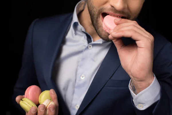 Young man with macaron — Stock Photo, Image