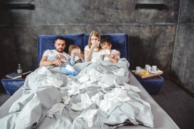 Sick family on bed clipart