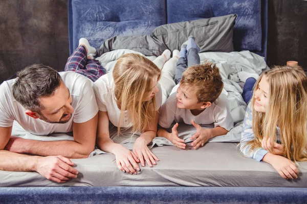 Familia feliz en la cama — Foto de Stock