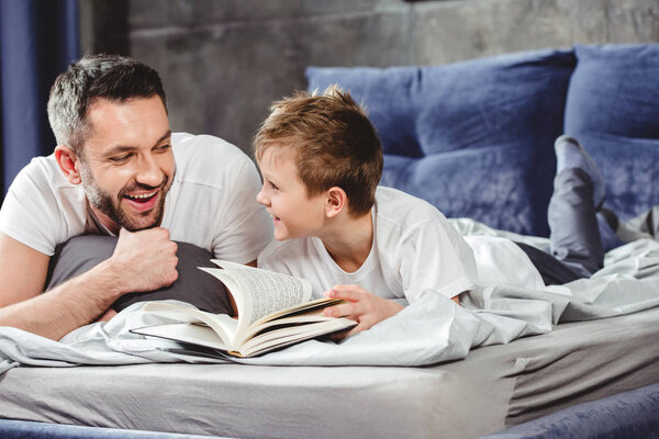 Father and son reading book  