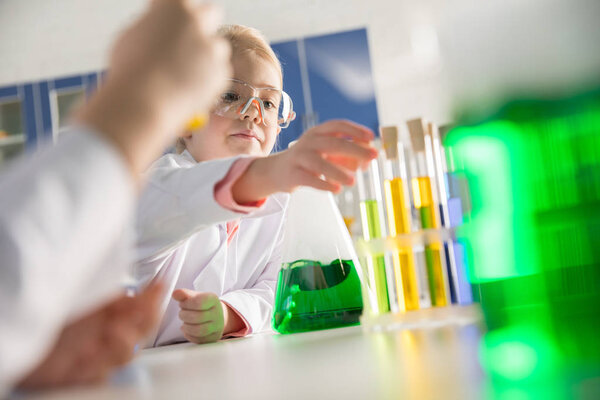 Schoolchildren making experiment