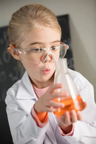 Girl holding flask with reagent — Stock Photo, Image