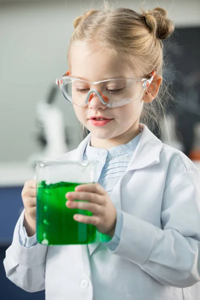 Girl holding flask with reagent — Free Stock Photo
