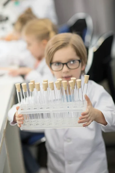 Boy with test tubes — Free Stock Photo