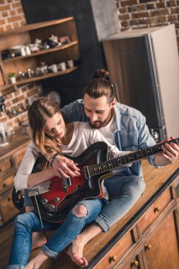 Young couple with guitar  clipart