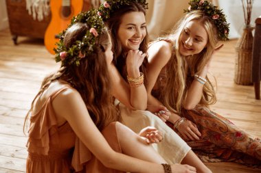 Women in boho style and floral wreaths