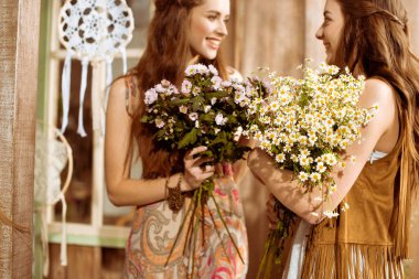 Bohemian women holding flowers  clipart