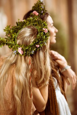 Bohemian women in floral wreaths clipart