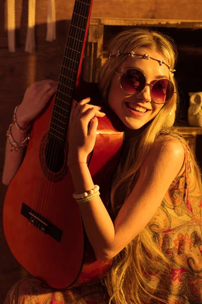 Woman in boho style posing with guitar — Stok fotoğraf