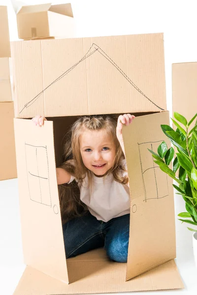 Girl sittling inside of cardboard box — Stock Photo, Image