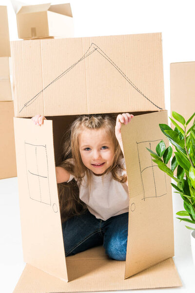 Girl sittling inside of cardboard box